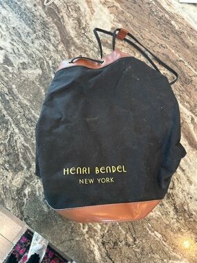 henri bendel Drawstring sling Backpack bucket bag has a few stains wear